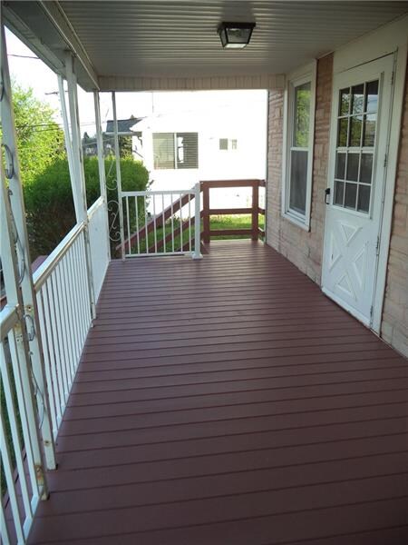 Freshly painted front porch with a new railing.