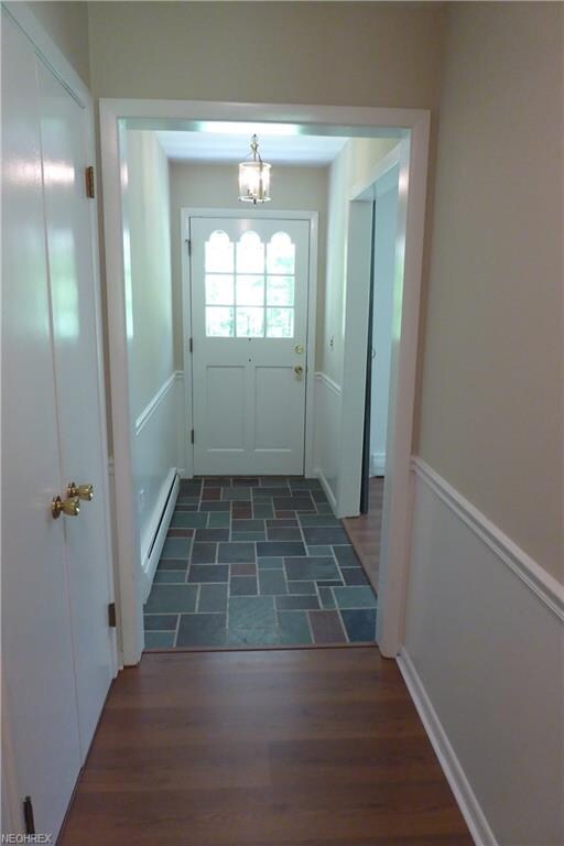 Bright welcoming slate foyer with large guest clos