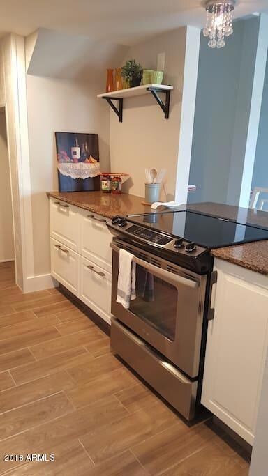 Kitchen with island side and drop-in ran