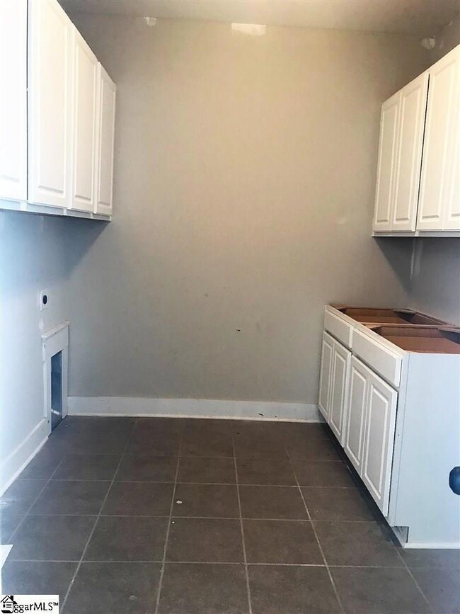 Laundry with additional cabinetry and counterspace