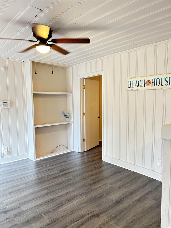 Spare room featuring a ceiling fan and wood finished floors