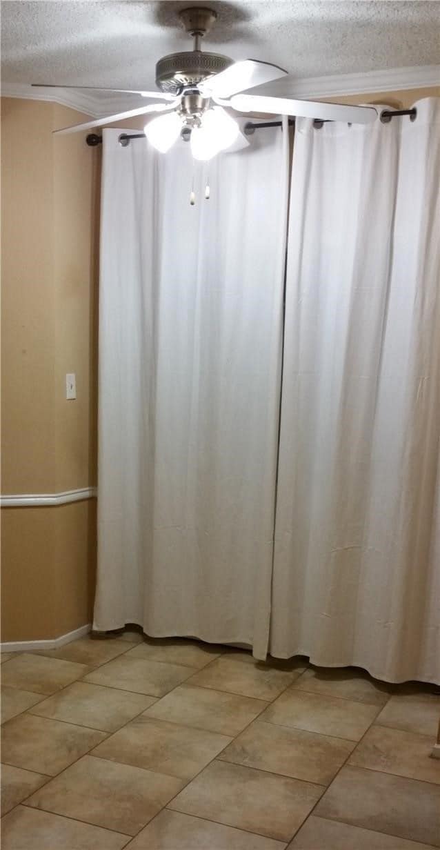 Flex Space off the kitchen can be used as a dining area or part of the Living Room features a ceiling fan. The Washer and Dryer are located behind the white canvas curtains in the utility closet
