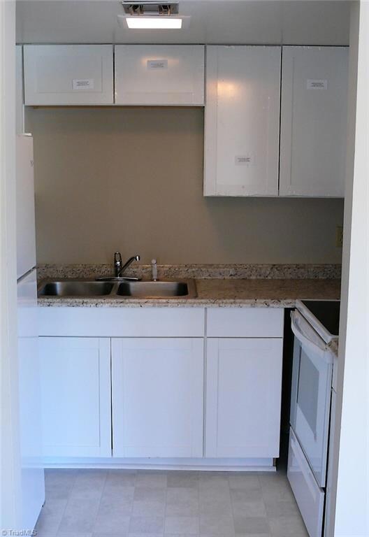 Kitchen -- New cabinets, appliances, floor, and countertops.