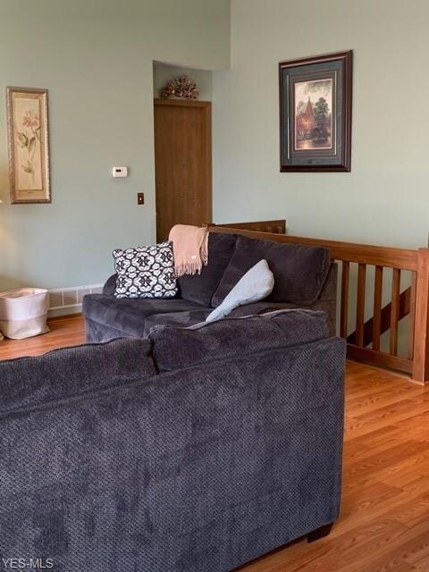 Main level living room with stair case leading to 