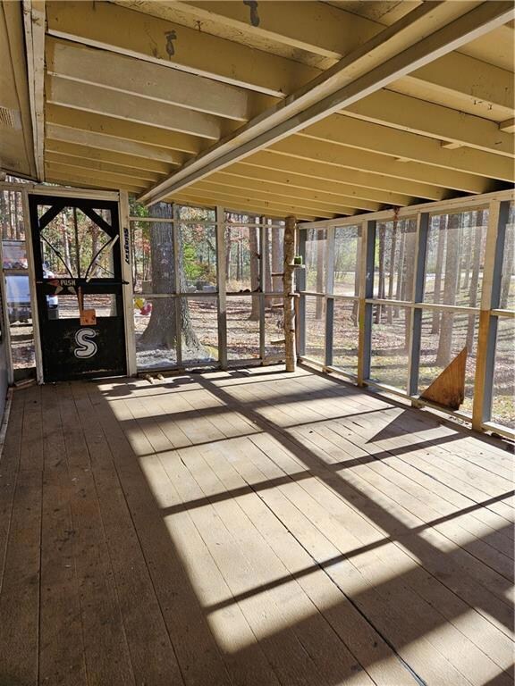 Unfurnished sunroom featuring plenty of natural li