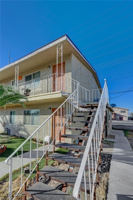 View of property exterior featuring stairway and s