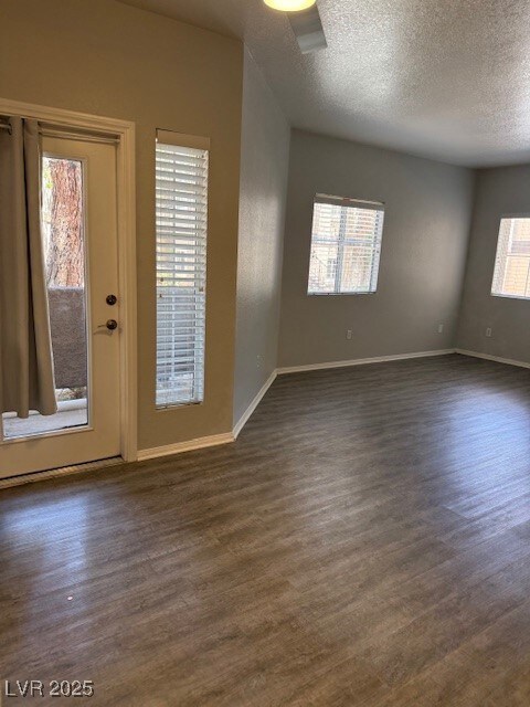 Unfurnished room featuring dark wood finished floo