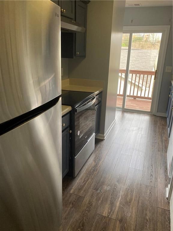 Kitchen with range hood, refrigerator, stainless s