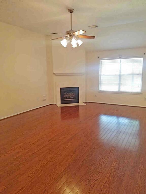 Large Den with wood floor, views to back yard and open to breakfast.