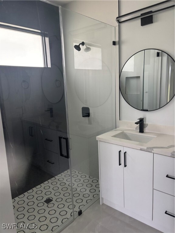 Full bath with vanity and a shower stall