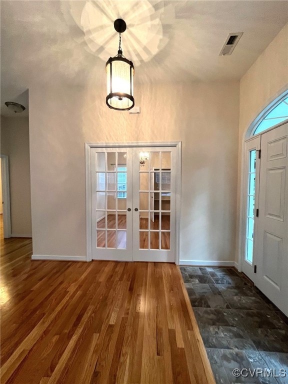 Entryway featuring french doors and wood finished
