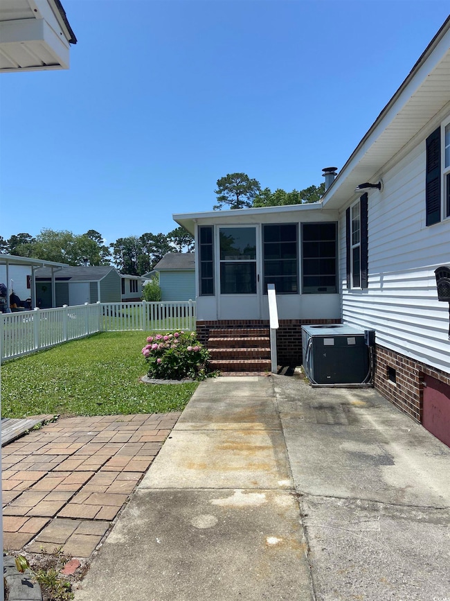 View of back patio and sunroom