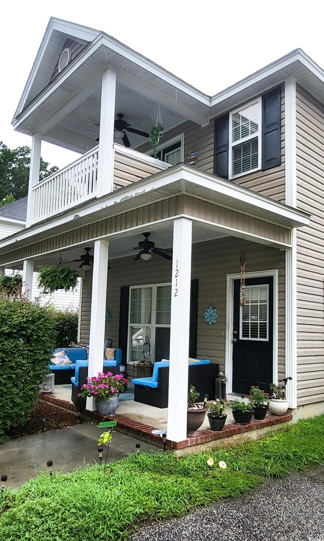Exterior space featuring ceiling fan and covered p