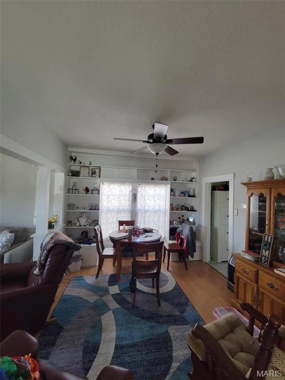 Dining room featuring a ceiling fan and wood finished floors