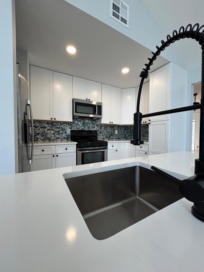 Kitchen with stainless steel appliances, tasteful