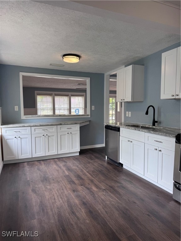 Kitchen with dishwasher, a sink, dark wood finishe