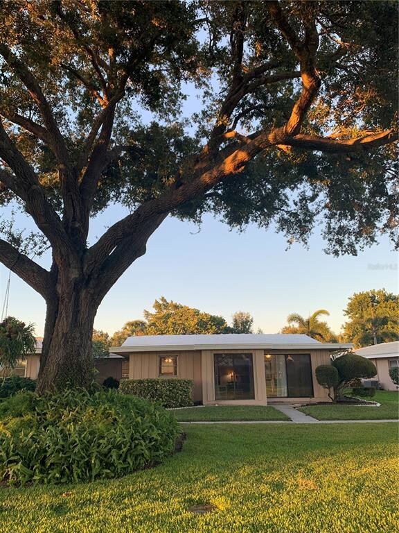Rear view of house surrounded by well maintained, 