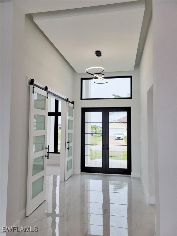 Foyer with custom ceiling & barn doors leading to