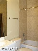 Bathroom featuring toilet, bathing tub / shower combination, and vanity