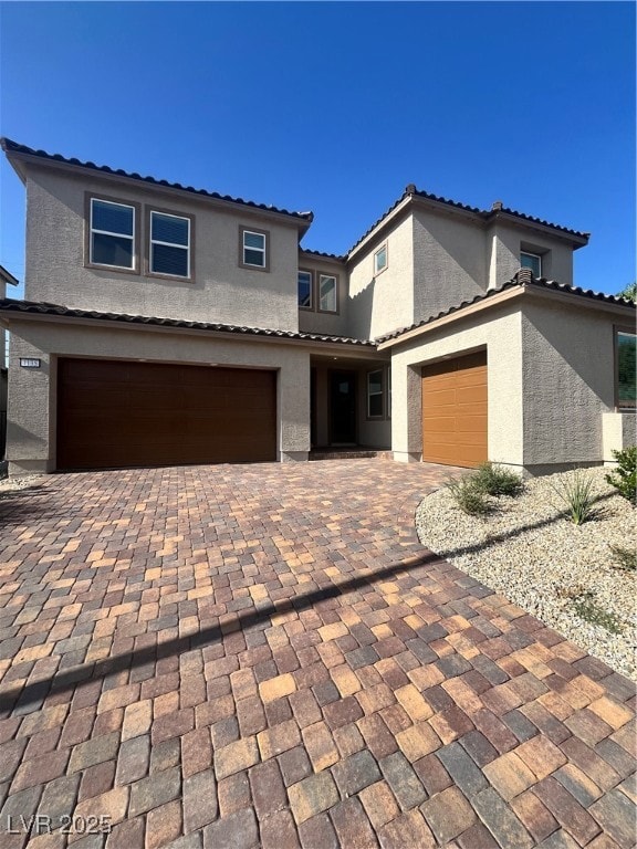 View of front facade featuring stucco siding, an a