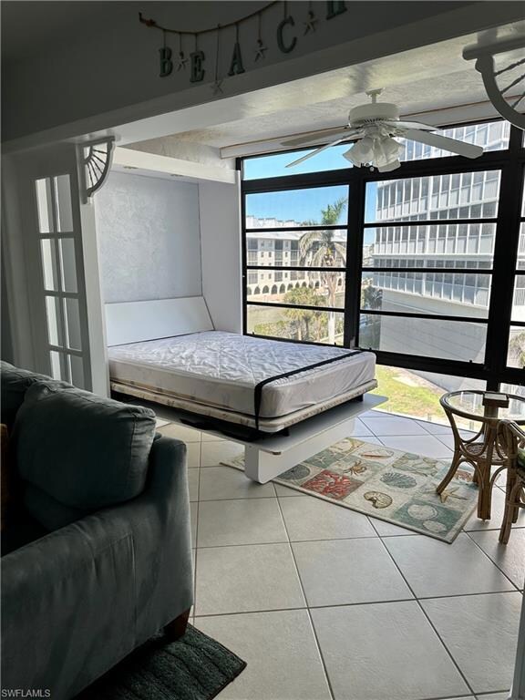 Tiled living room with a ceiling fan