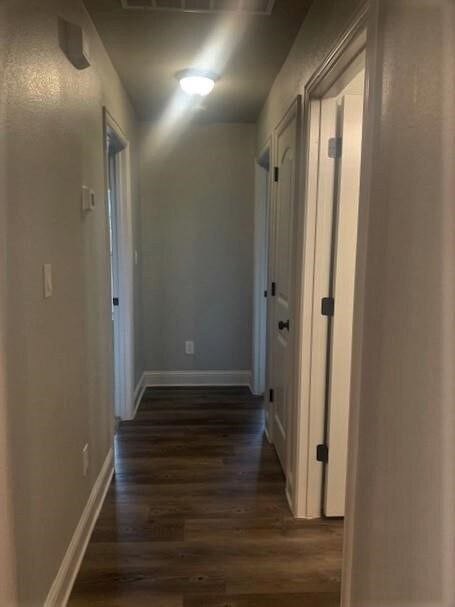 Hall with wood finished floors and baseboards
