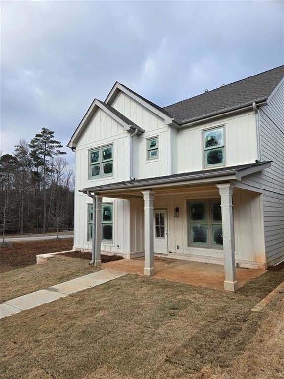View of front facade with board and batten siding,