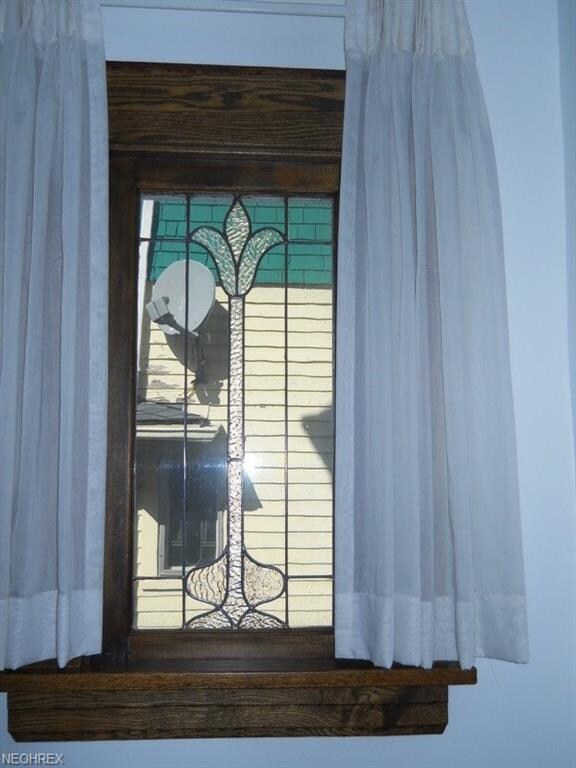 Unique leaded-glass windows in living room and dining room.