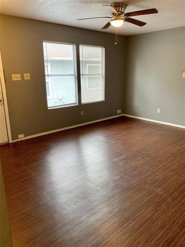 Unfurnished room featuring dark wood-type floorin