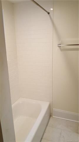 New tub shower with ceramic tile surround