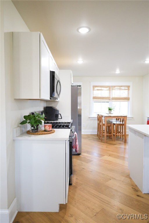 Kitchen with stainless steel appliances, recessed