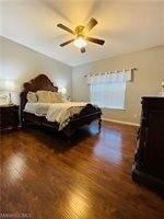 Bedroom featuring wood finished floors and ceiling fan