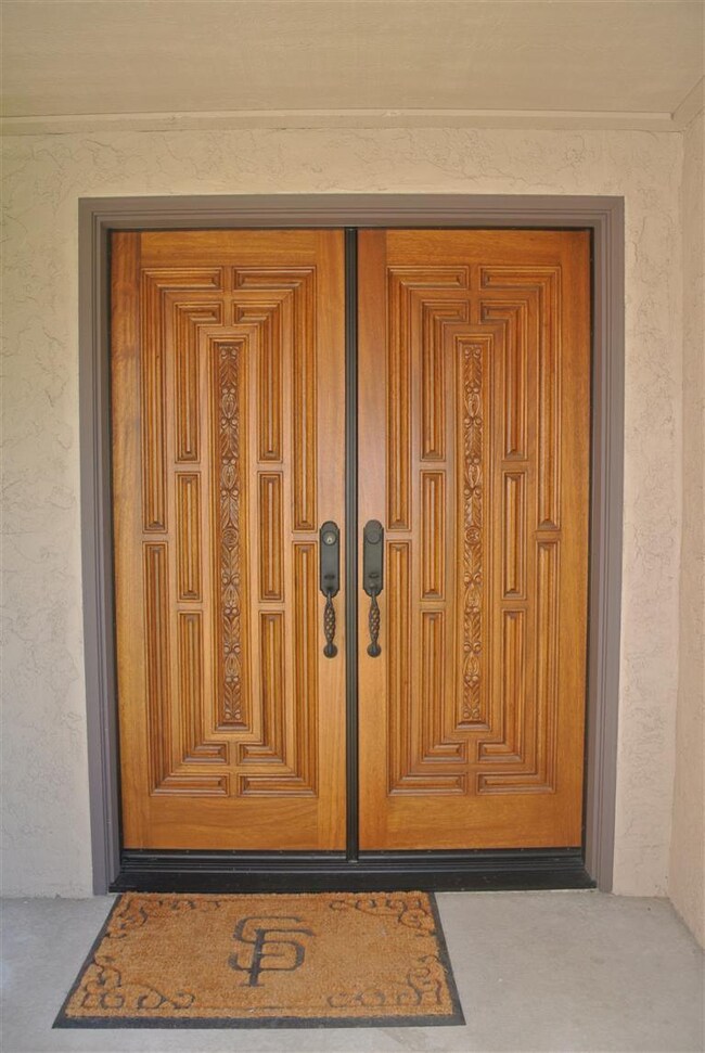 Mahogany double doors with wrought iron hardware