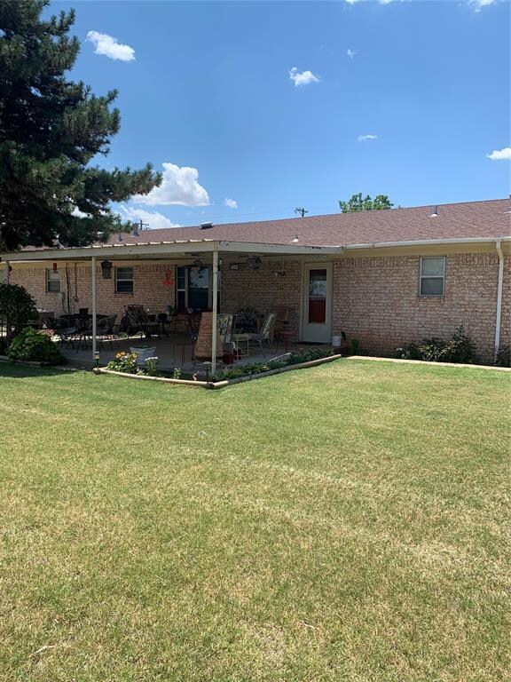 Rear view of property featuring a patio area and a