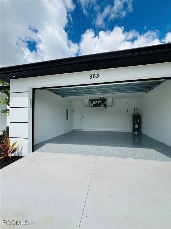 Garage with water heater and driveway