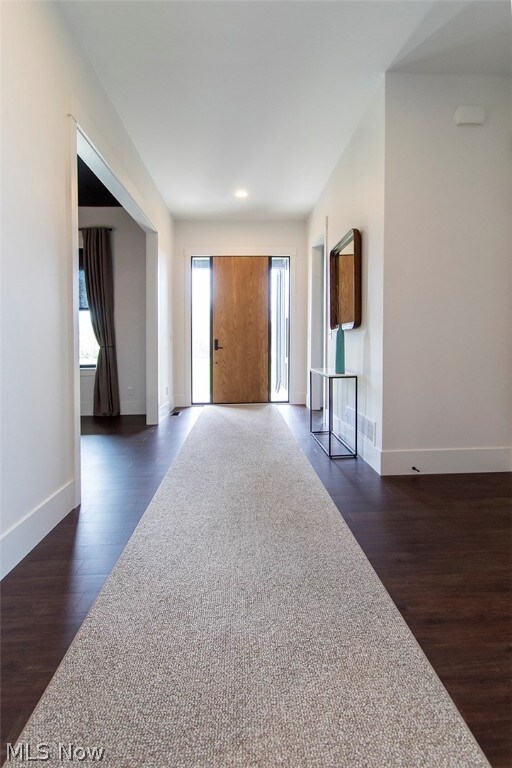 Entrance foyer with dark hardwood / wood-style floors