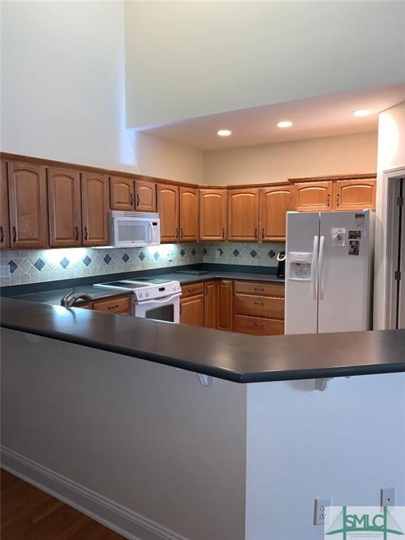 Large kitchen with tons of cabinets and a very lon