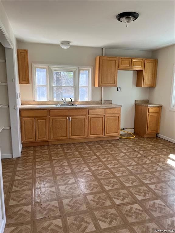 Kitchen featuring healthy amount of natural light and light countertops