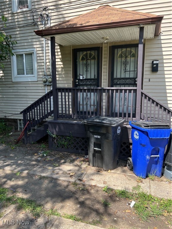 View of exterior entry featuring covered porch