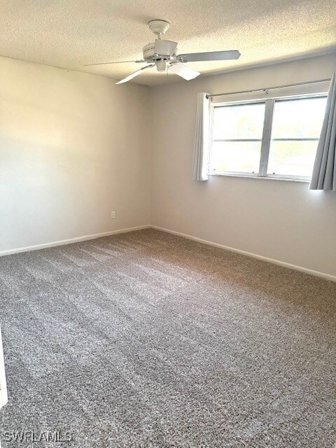 Unfurnished room featuring baseboards, a ceiling f