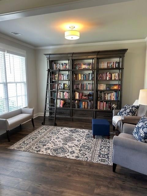 Living area with crown molding, wood finished floors, and baseboards