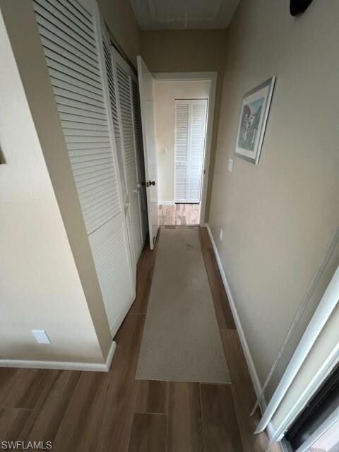 Hallway with attic access, dark wood finished floo