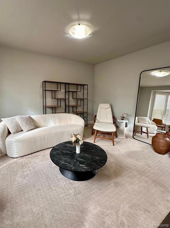 Carpeted living area featuring baseboards