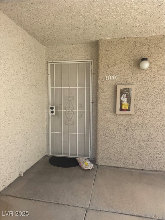 Property entrance with stucco siding