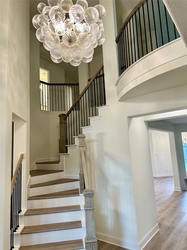 Entry and stairs with new stair system, flooring and lighting.