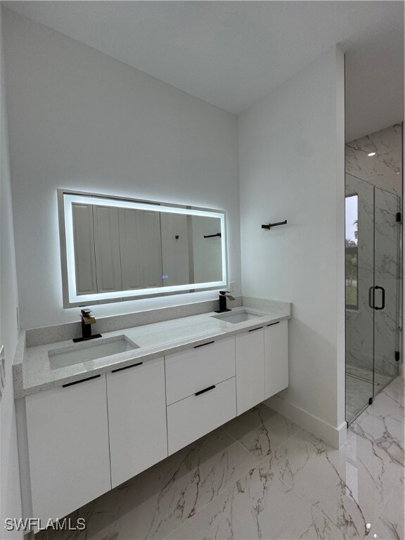 Bathroom featuring vanity and a shower with shower