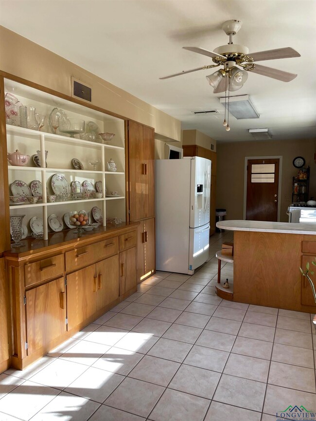 Kitchen featuring white refrigerator with ice disp