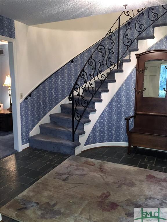 Pretty entrance foyer with curved staircase and th
