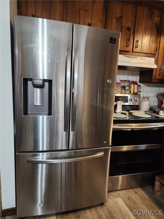 Kitchen featuring stainless steel appliances, unde