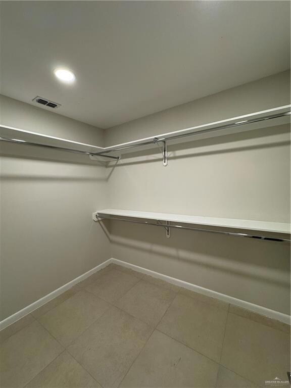 Walk in closet with tile patterned floors and visible vents